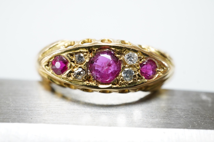 A ruby and diamond ring, circa 1916, set with three circular-cut rubies, spaced by pairs of circular-cut diamonds, mounted in 18ct gold, size R1/2, British hallmarks, gross weight approximately 2 grams, one ruby syntheti